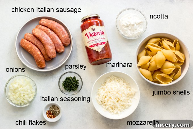 Golden Baked Italian Sausage Stuffed Shells 3 Close-up of fresh ingredients for Italian sausage stuffed shells including jumbo pasta shells, chicken sausage, marinara, cheeses, onion, and spices.