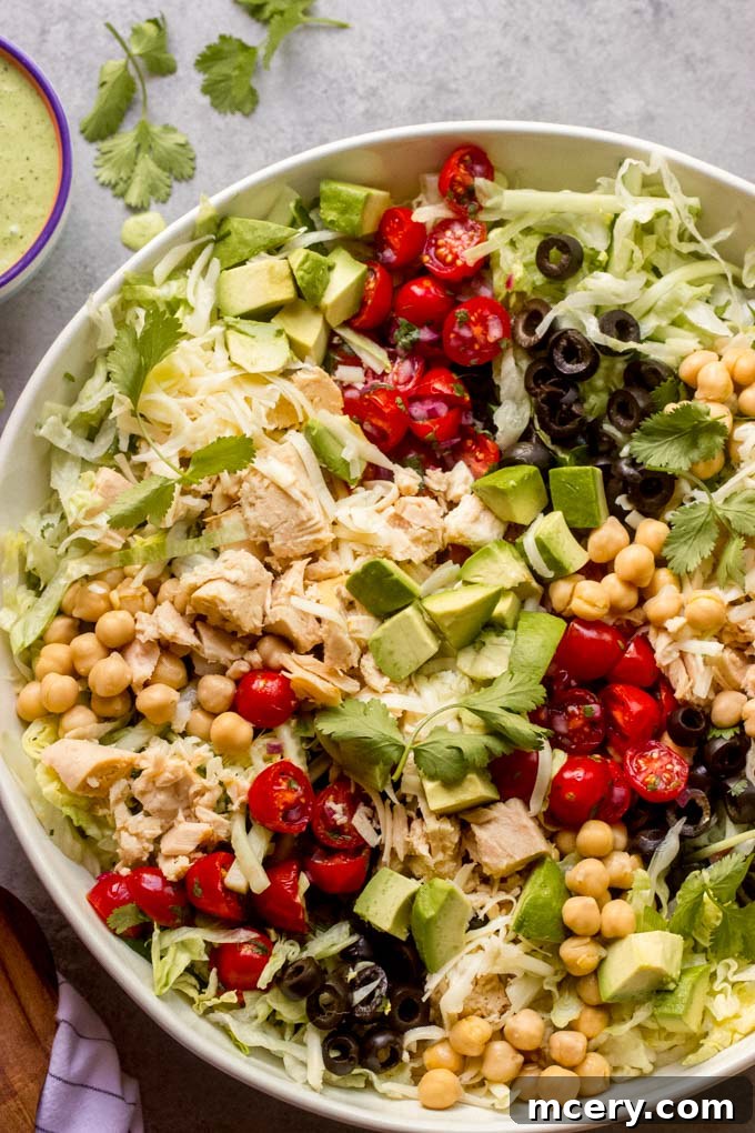 Zesty Mexican Tuna Salad with Cilantro Cream 3 Close-up of a beautifully layered Chopped Mexican Tuna Salad in a bowl, showcasing fresh ingredients like avocado, pico de gallo, and tuna.