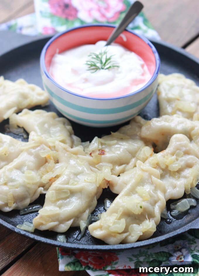Pillowy Potato Pierogi 4 Freshly made perogies ready for cooking, neatly arranged on a baking sheet.