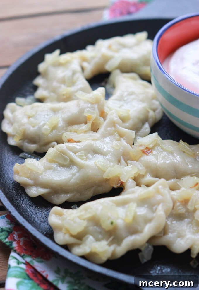 Pillowy Potato Pierogi 5 A batch of golden potato perogies perfectly boiled and ready to be served.