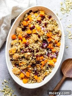 Butternut squash cranberry quinoa salad in an oval white bowl