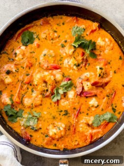 A delicious bowl of Thai Red Curry Shrimp, garnished with fresh cilantro.