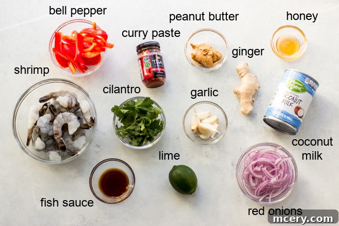Creamy Thai Red Curry with Succulent Shrimp 2 A vibrant selection of fresh ingredients including red onion, bell peppers, ginger, garlic, and cilantro, ready for red curry shrimp preparation.