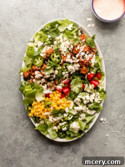 close-up of ground turkey taco salad in a white bowl with cilantro ranch dressing