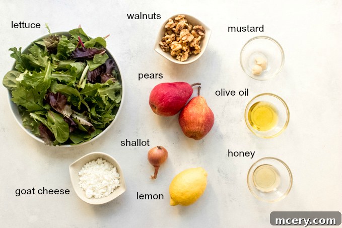 Caramelized Pear & Chevre Salad 4 A flat lay photograph showcasing all the fresh and colorful ingredients needed for roasted pear salad, including whole pears, mixed greens, goat cheese, walnuts, and vinaigrette components