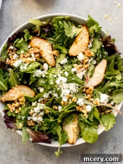 Delicious roasted pear salad recipe with goat cheese, walnuts, and lemon vinaigrette, perfect for fall season