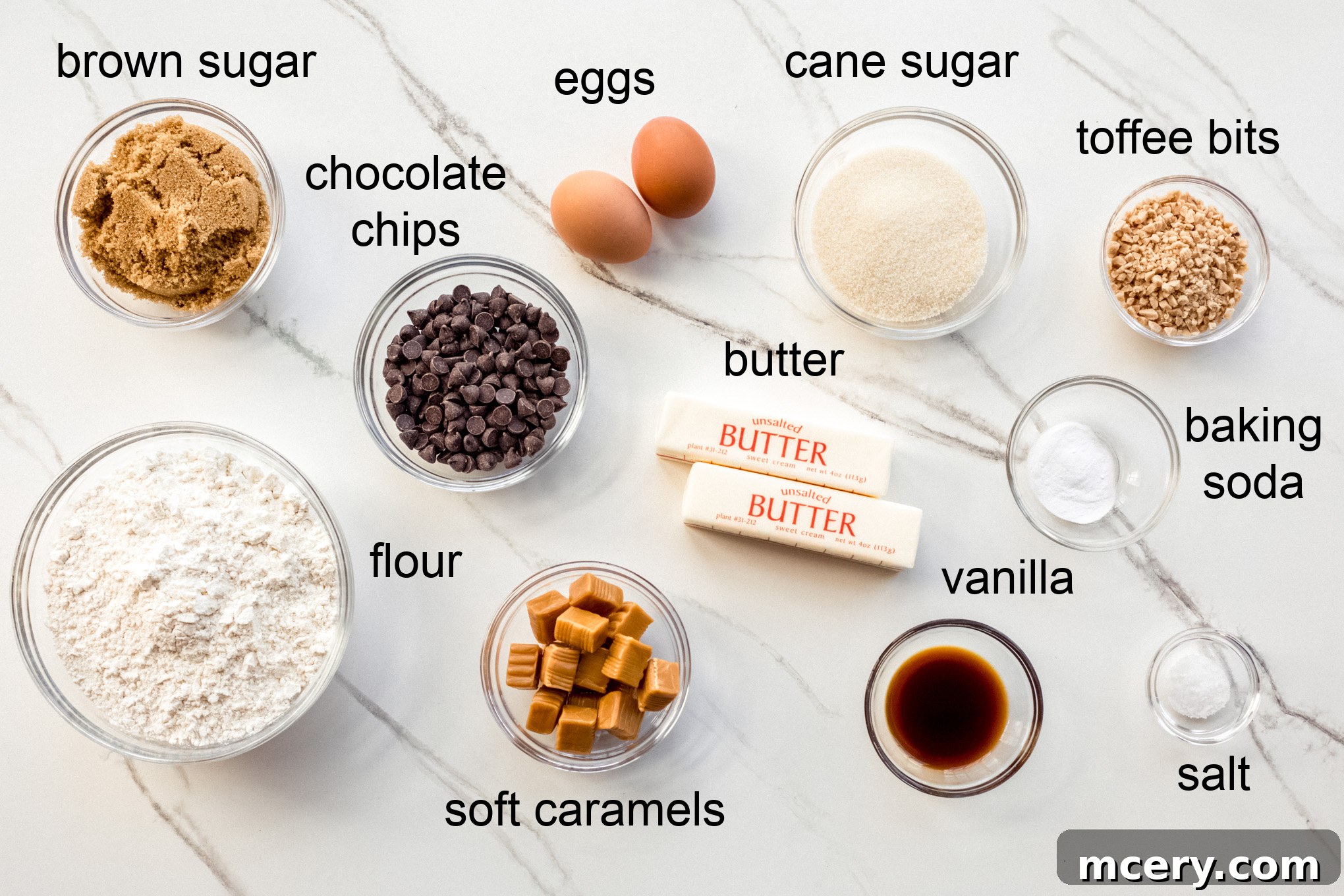 A curated collection of ingredients for baking toffee cookies with caramel, meticulously laid out on a clean surface.