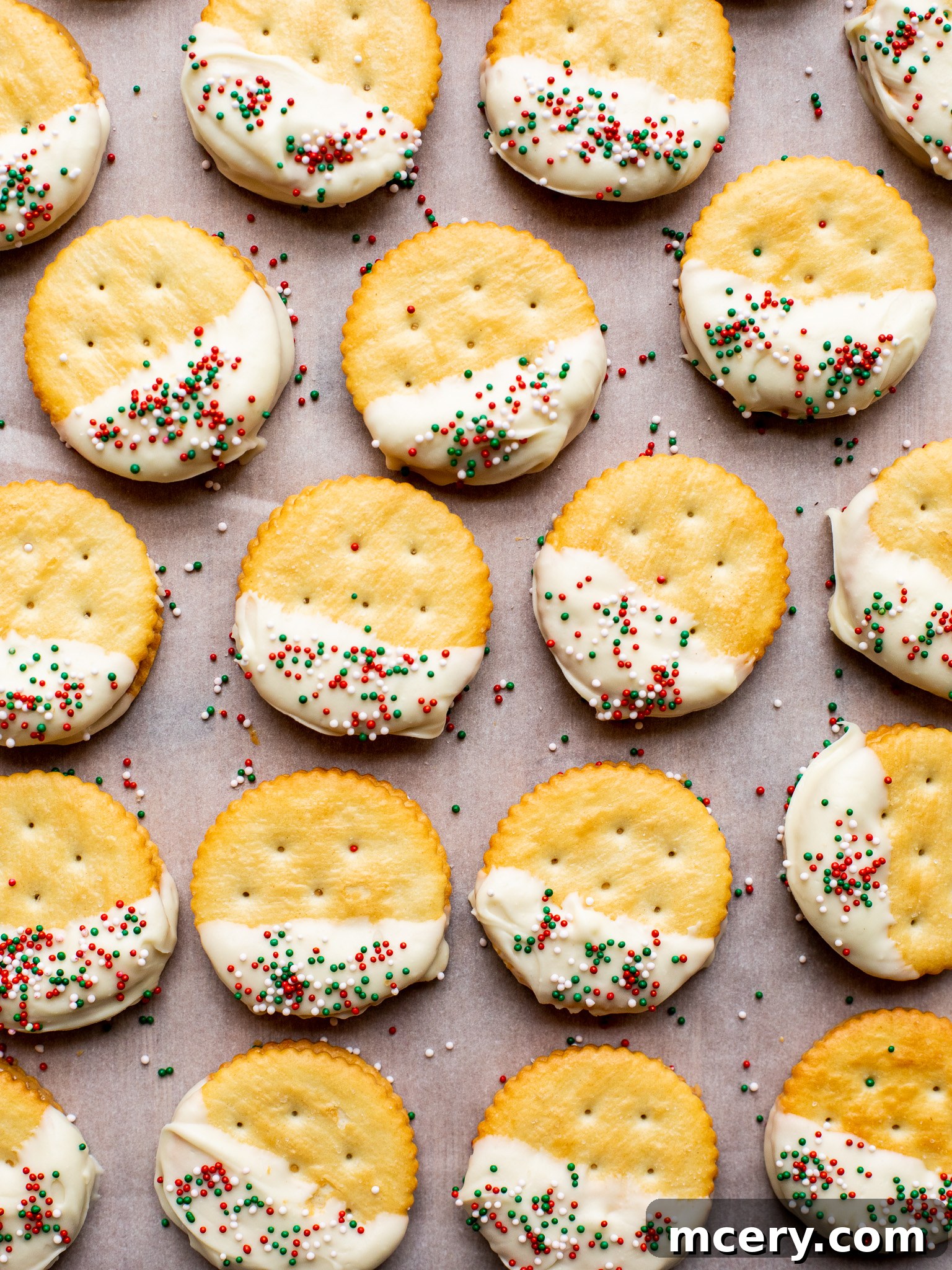 Golden Sweet Salty Cookie Crunch 2 Delicious no-bake Ritz Cracker Cookies topped with colorful sprinkles, presented on a white plate.