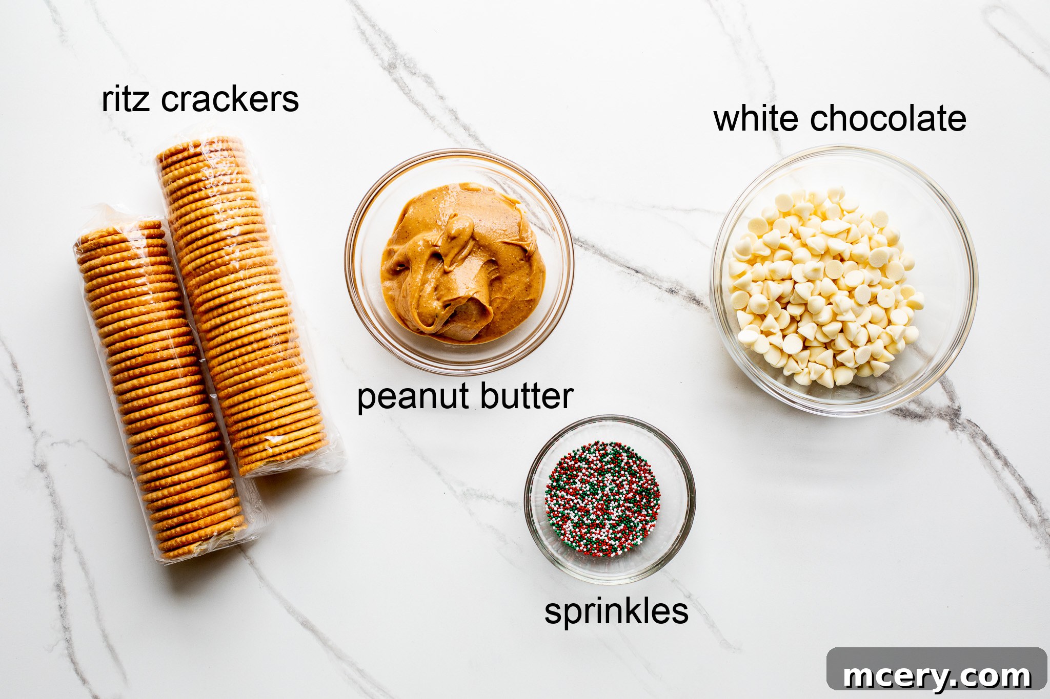 Golden Sweet Salty Cookie Crunch 3 A selection of ingredients for making no-bake Ritz Cracker Cookies, including crackers, creamy peanut butter, white chocolate chips, and colorful sprinkles, laid out on a wooden surface.