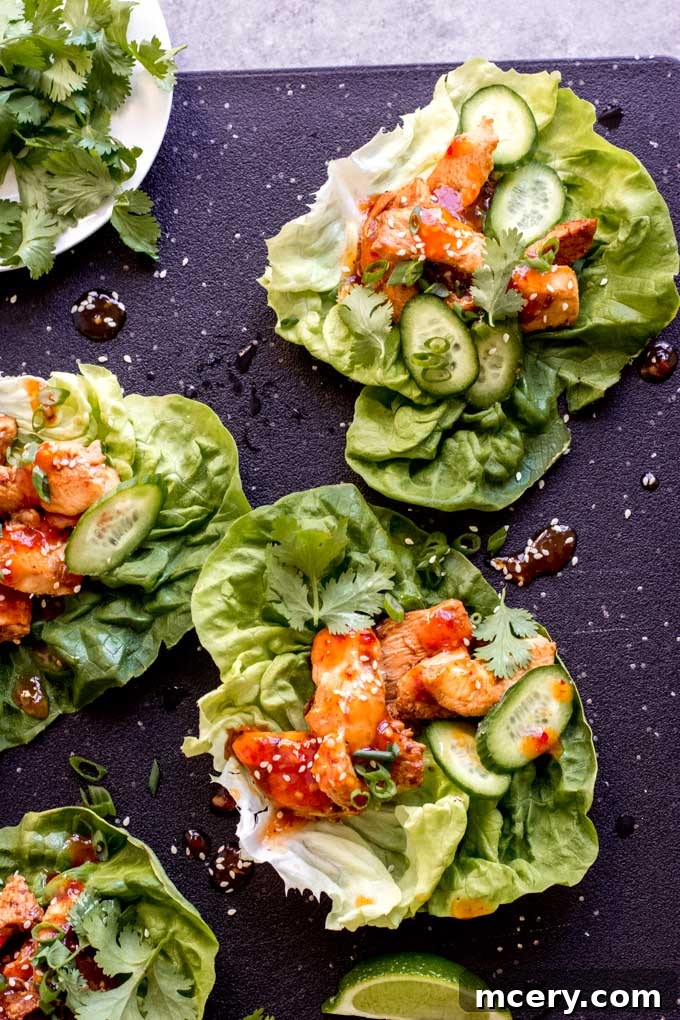 Zesty Korean Chicken Lettuce Cups 7 Close-up of a Korean chicken lettuce wrap showing the filling and fresh toppings
