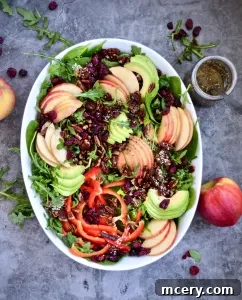 Beautifully plated Harvest Salad with crisp apples, creamy avocado, and toasted pecans