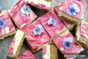 Beautifully sliced No-Bake Lemon Raspberry Bars showcasing their vibrant yellow and pink layers on a rustic wooden board.