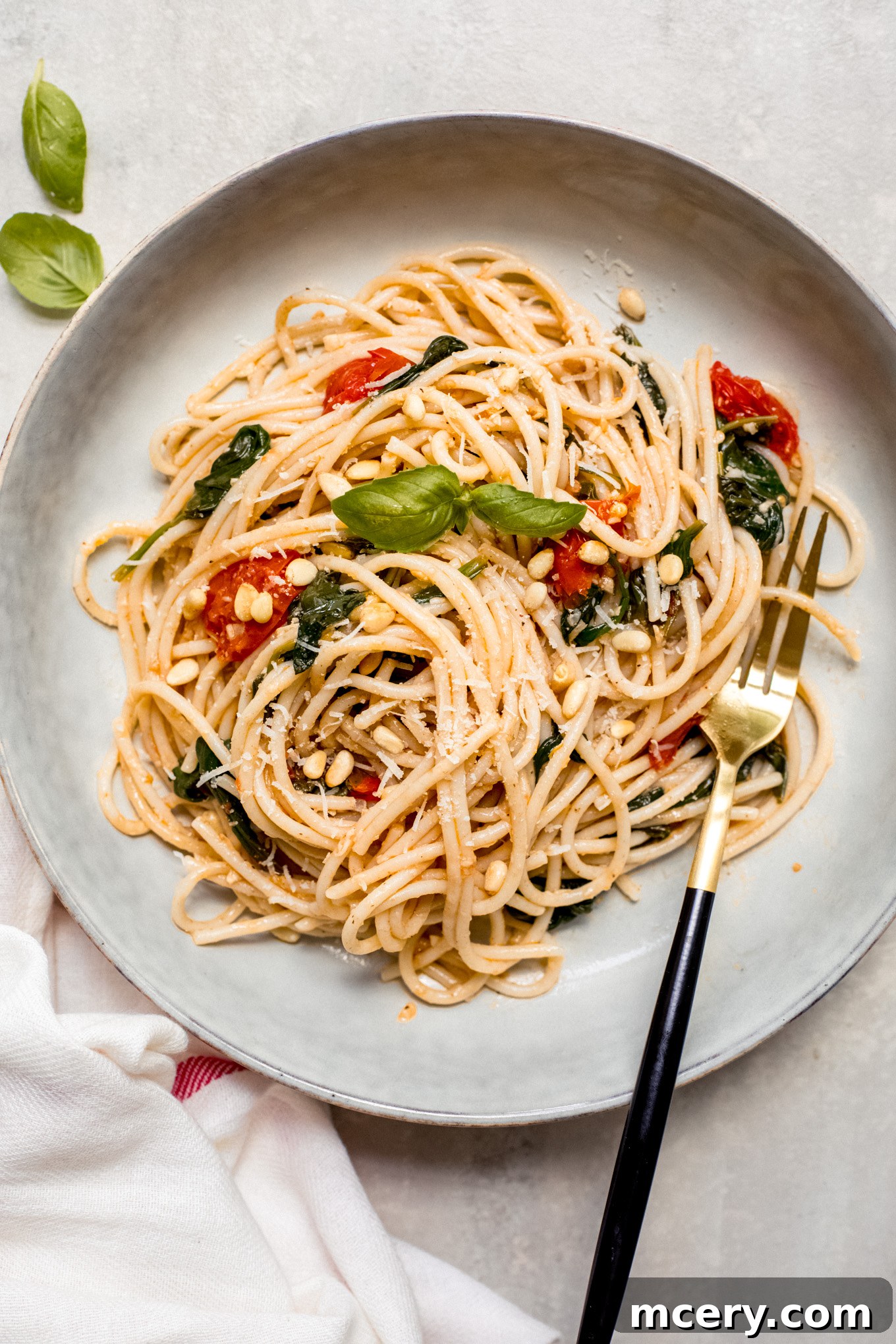 Garden Fresh Spinach and Tomato Pasta 8 spaghetti with fresh tomato sauce in a bowl with a side of fork.
