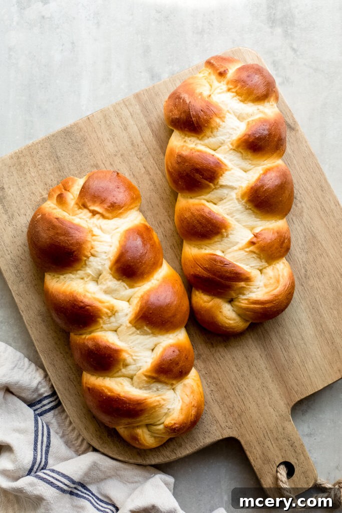 Golden Swiss Zopf 2 swiss braided bread - a golden brown braided loaf on a cutting board