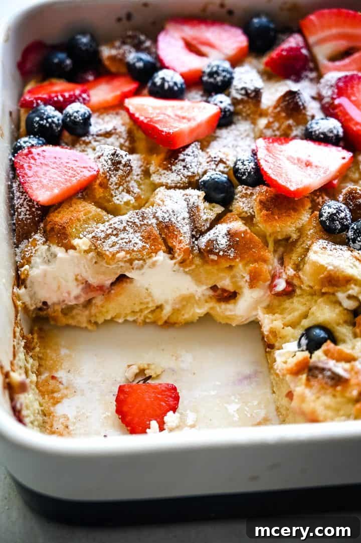 Creamy Berry Baked French Toast 4 Ingredients for Berries and Cream French Toast Bake, including brioche bread cubes, fresh berries, cream cheese, and a bowl of egg mixture.