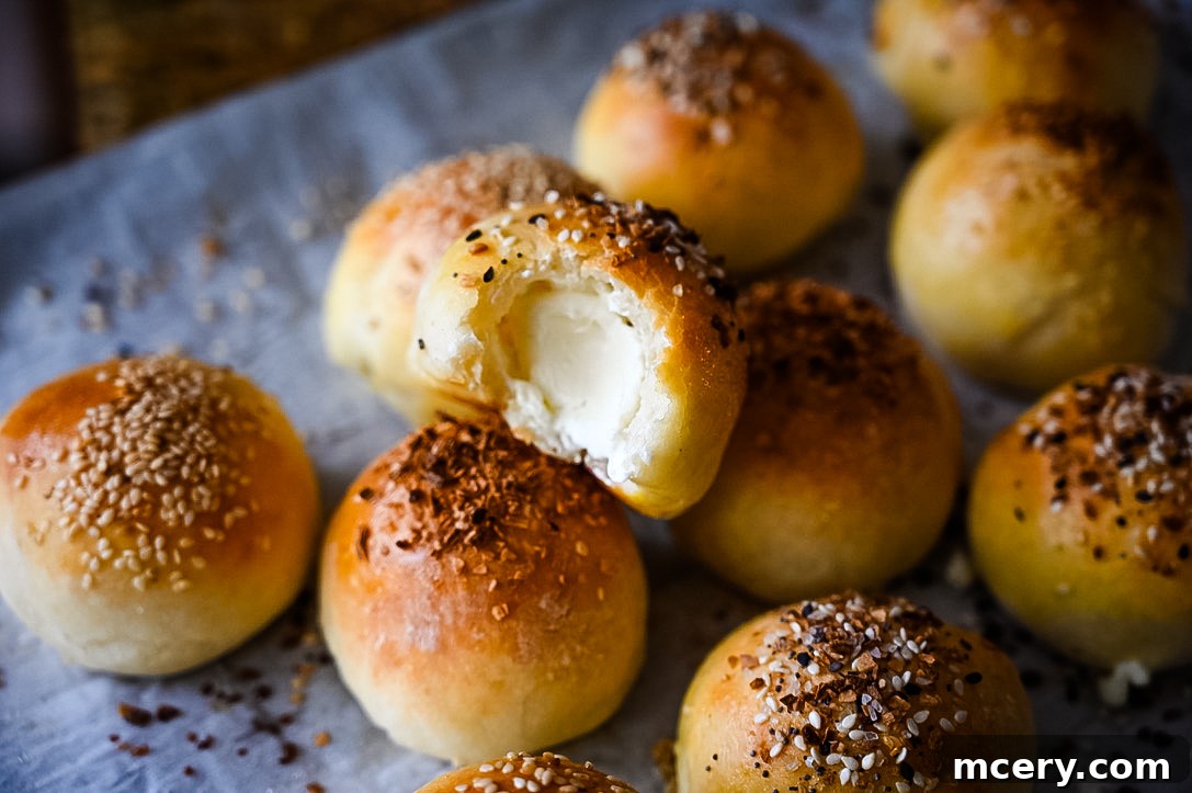 Bagel Bombs 4 Assortment of golden-brown stuffed bagel bites, perfectly baked and ready to eat, scattered on a surface.