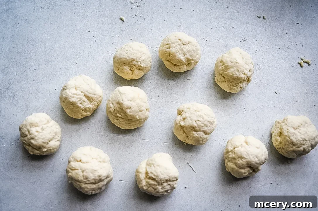Bagel Bombs 8 The edges of the dough being carefully pinched together to enclose the cream cheese filling.