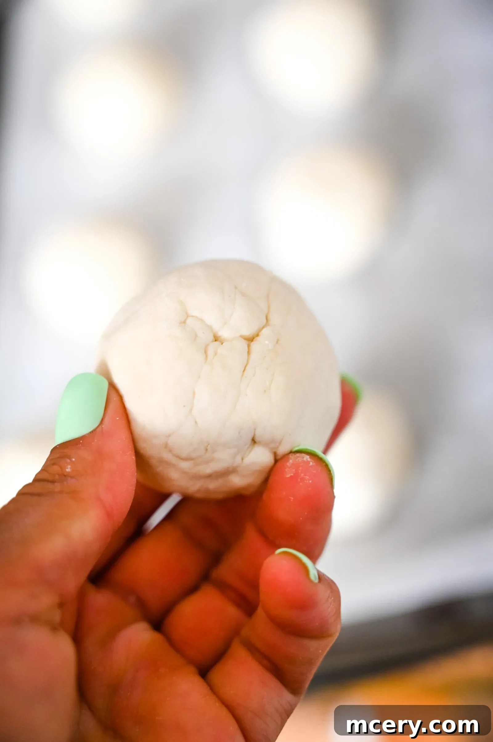 Bagel Bombs 10 A close-up of several unbaked stuffed bagel bites, brushed with egg wash and ready for seasoning.