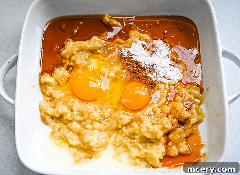 Delicious and Nutritious Banana Bread Baked Oatmeal 5 Overhead view of a rectangular baking dish filled with Banana Bread Baked Oatmeal, steaming slightly, ready for serving.