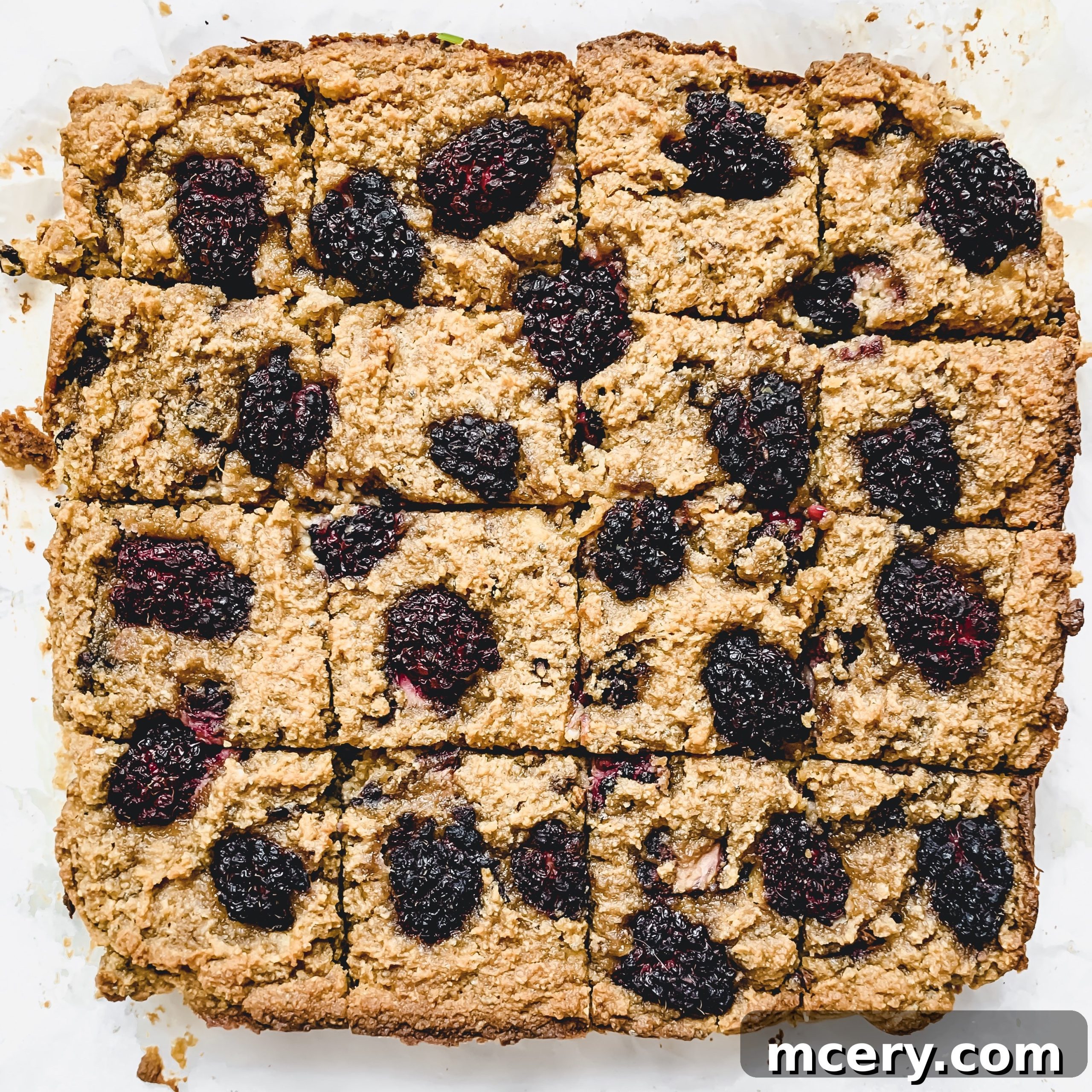 Blackberry Banana Bliss Bars 2 Delicious One-Bowl Blackberry Banana Bread Bars, golden brown and topped with fresh blackberries
