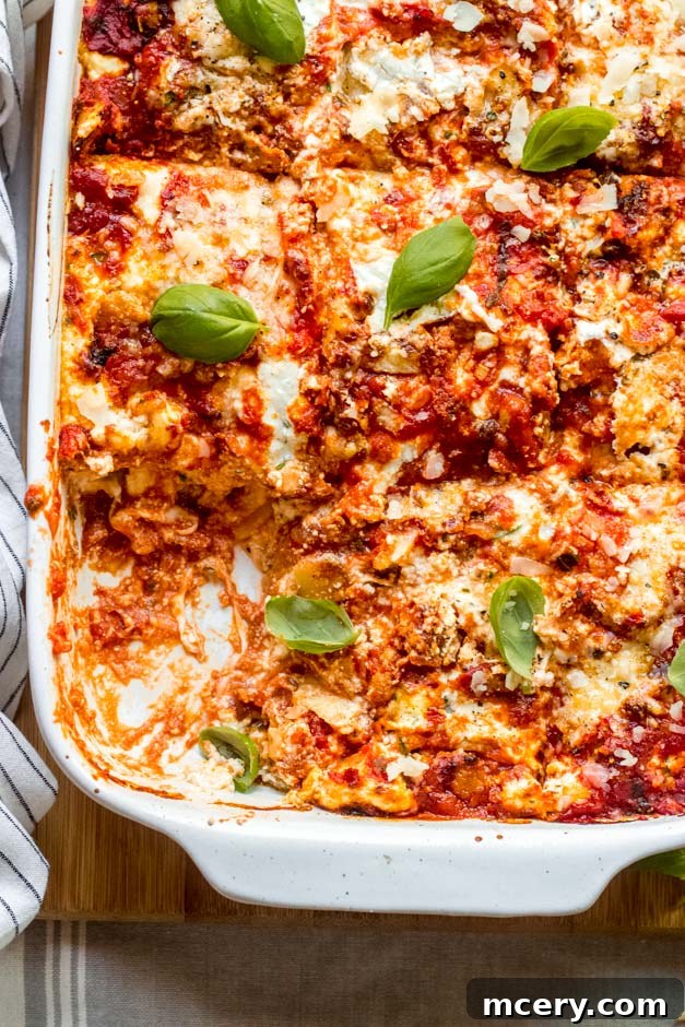 Barefoot Contessa's Turkey Lasagna 4 close up turkey sausage lasagna in casserole dish.