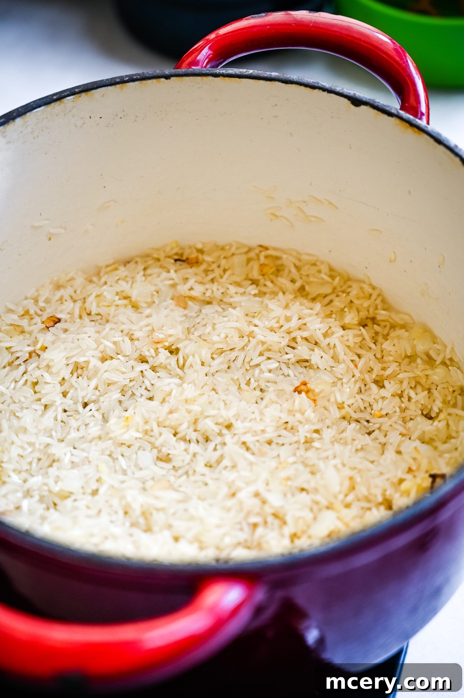Perfect One-Pot Black Beans and Rice Side 5 A red pot filled with perfectly cooked, fluffy white rice, ready to be combined with black beans and other vibrant ingredients for a delicious one-pot meal.