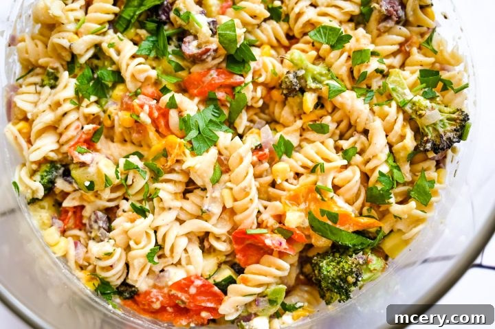 Mediterranean Hummus Pasta Delight 4 Hummus Pasta Salad served in a large bowl, garnished with fresh parsley.