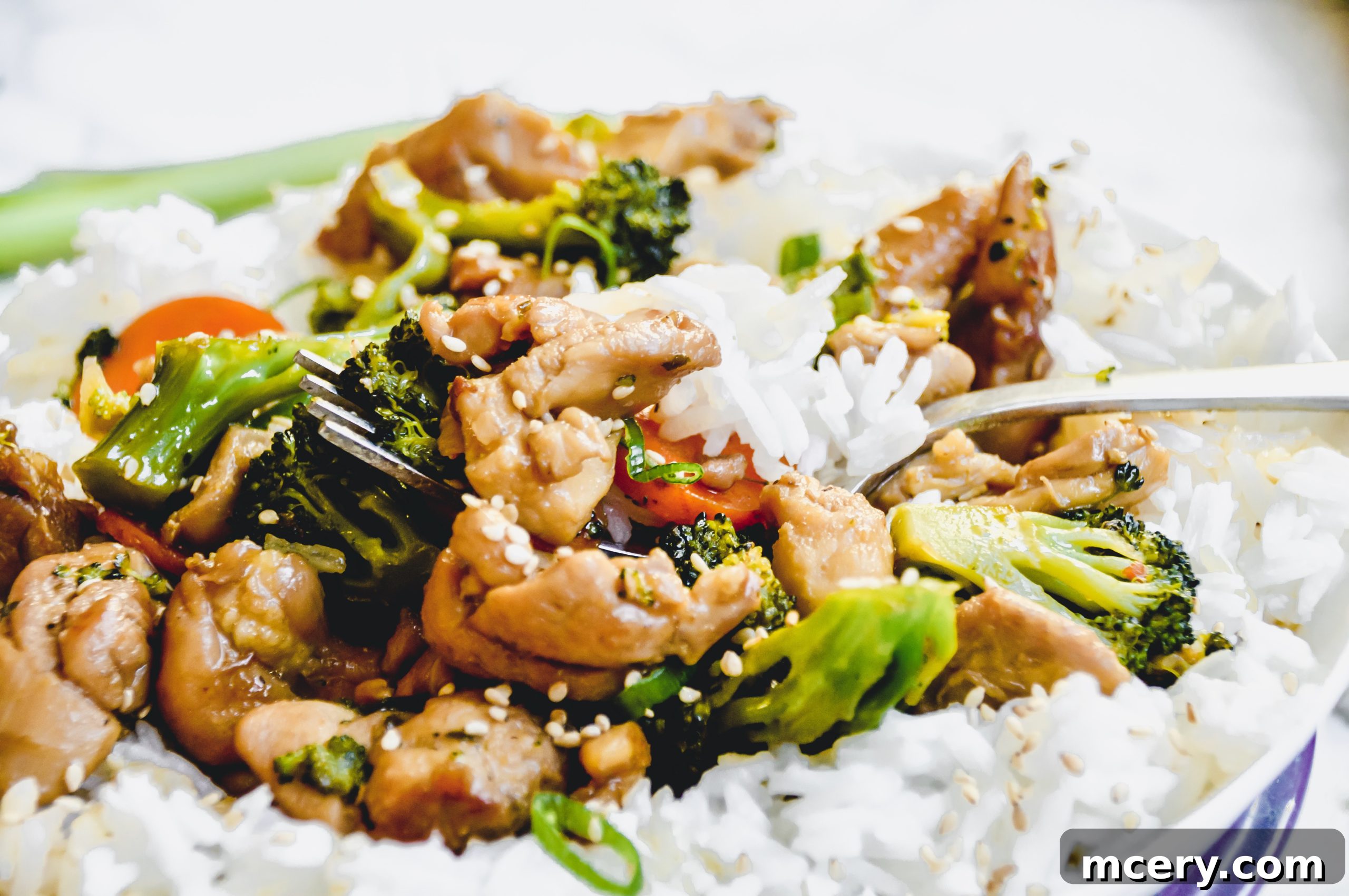 Quick and Flavorful Teriyaki Chicken Rice Bowls 3 Close-up view of a vibrant Teriyaki Chicken and Rice Bowl, showcasing the glossy sauce on chicken, broccoli, and carrots.