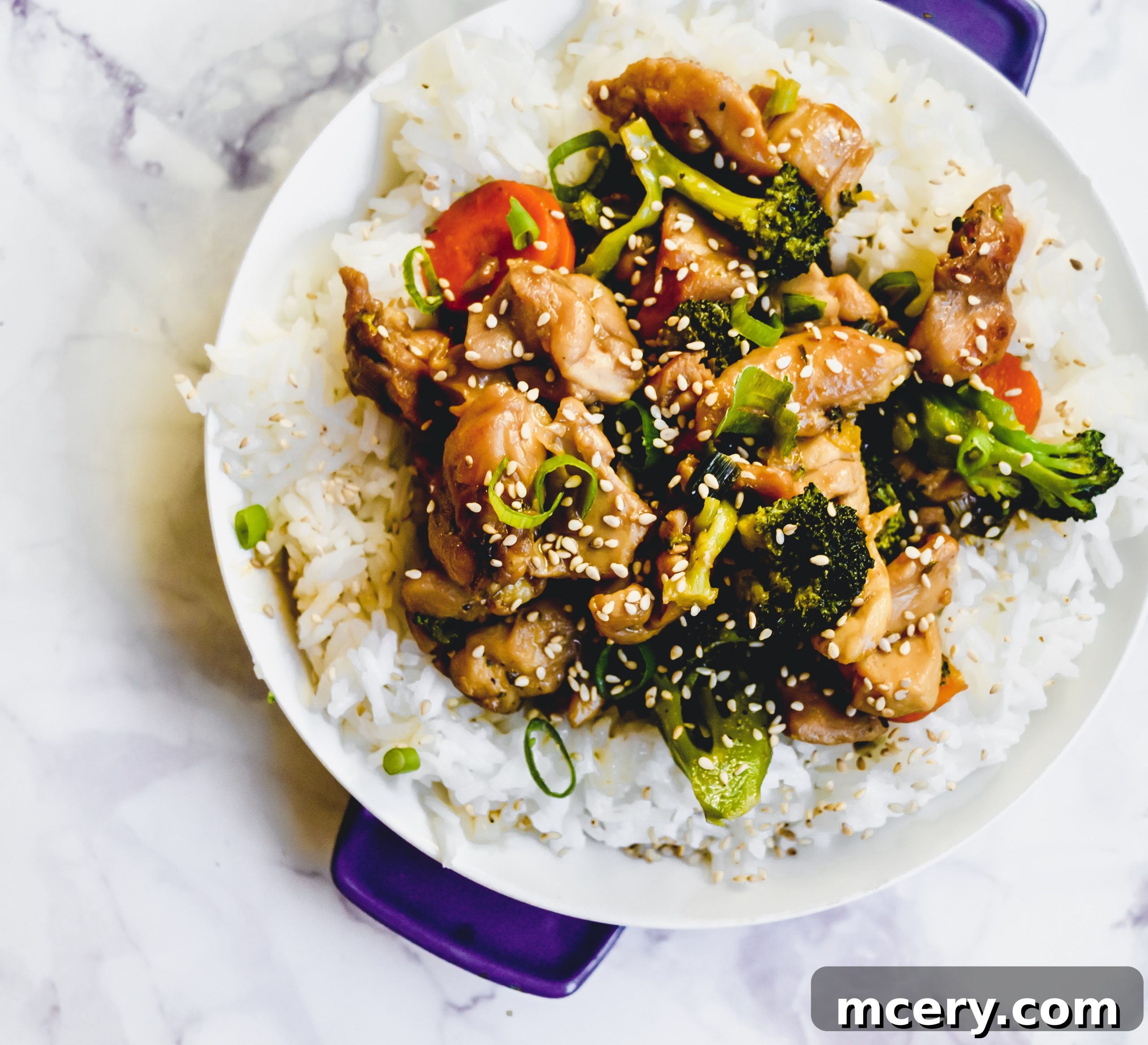 Quick and Flavorful Teriyaki Chicken Rice Bowls 5 Freshly chopped broccoli florets, carrots, and vibrant green onions prepared for cooking in a Teriyaki Chicken Bowl.