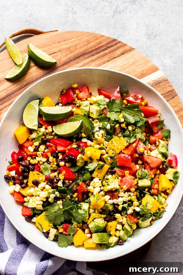 Fiesta Chopped Salad 5 Overhead Mexican salad in white bowl on board.