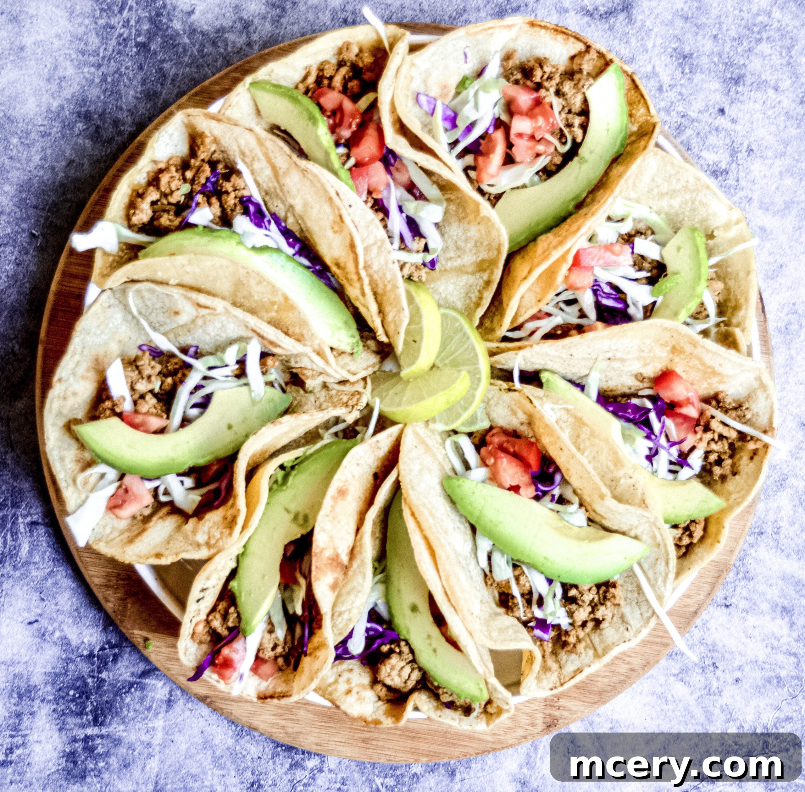 Flavorful & Fast Turkey Tacos 8 Three perfectly assembled ground turkey tacos on a light plate, ready to be enjoyed.