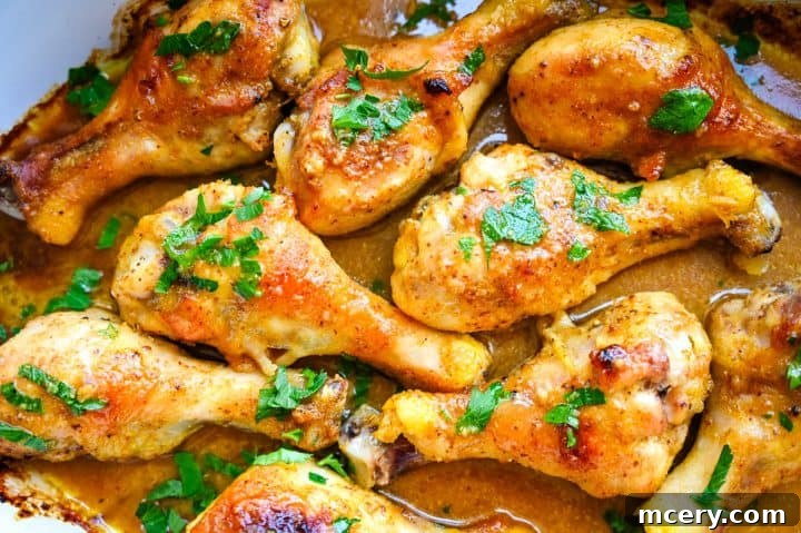 Sticky Honey Mustard Glazed Chicken Drumsticks 3 A close-up of honey mustard baked chicken drumsticks, showing their glistening, caramelized glaze.
