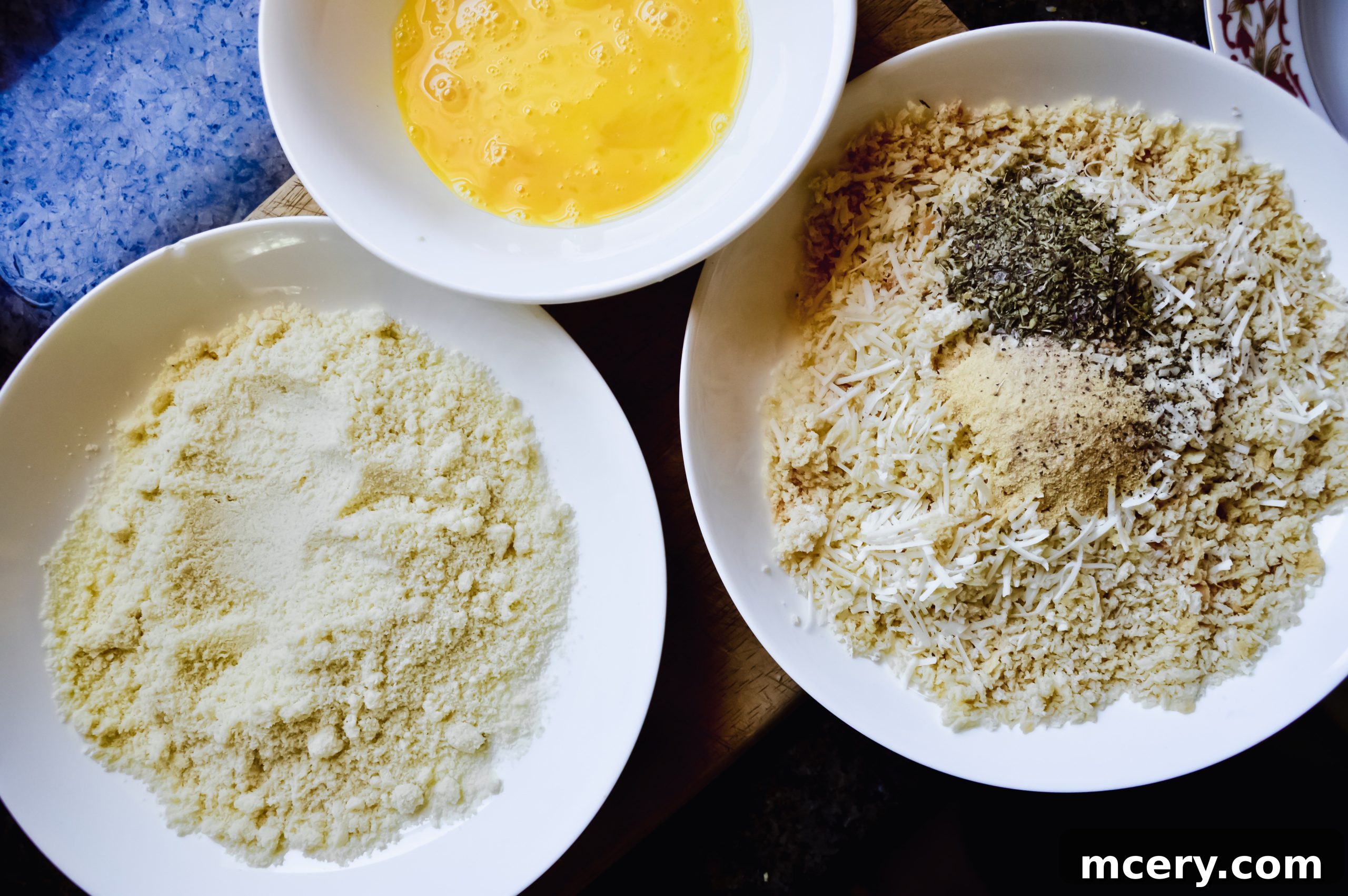 Parmesan Crusted Gluten-Free Chicken 3 Ingredients laid out for Gluten-Free Parmesan Chicken Cutlets: chicken, eggs, flour, panko, and herbs.
