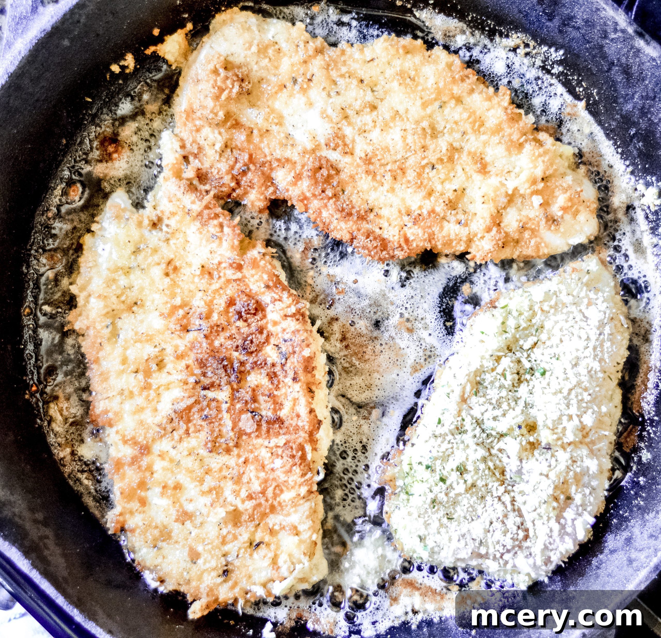 Parmesan Crusted Gluten-Free Chicken 5 A chicken cutlet being coated in the panko-Parmesan mixture.