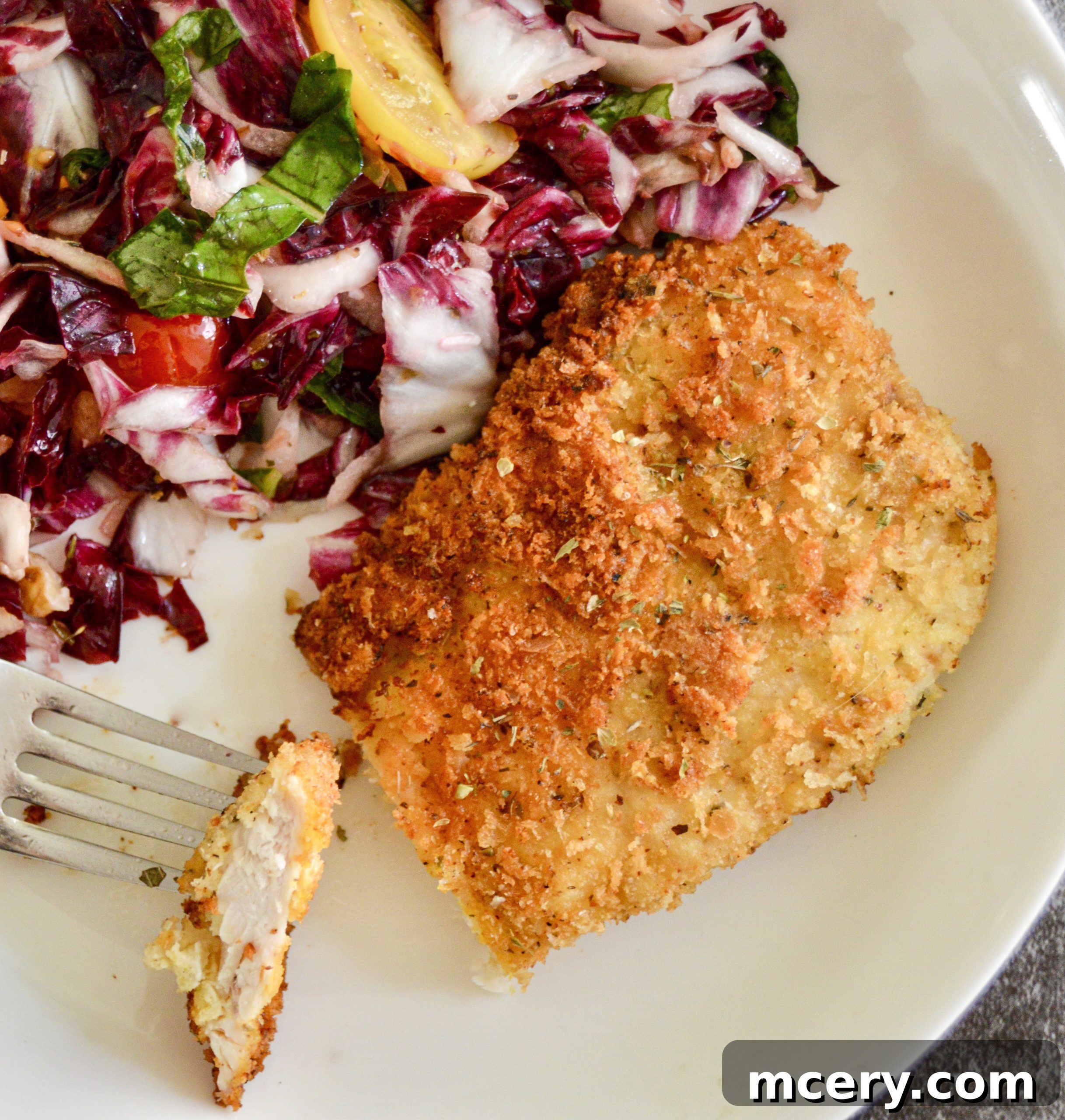 Parmesan Crusted Gluten-Free Chicken 7 Gluten-Free Parmesan Chicken Cutlets served on a plate with fresh basil.