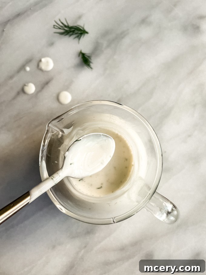 Homemade Buttermilk Ranch Dressing close-up, creamy and garnished with dill
