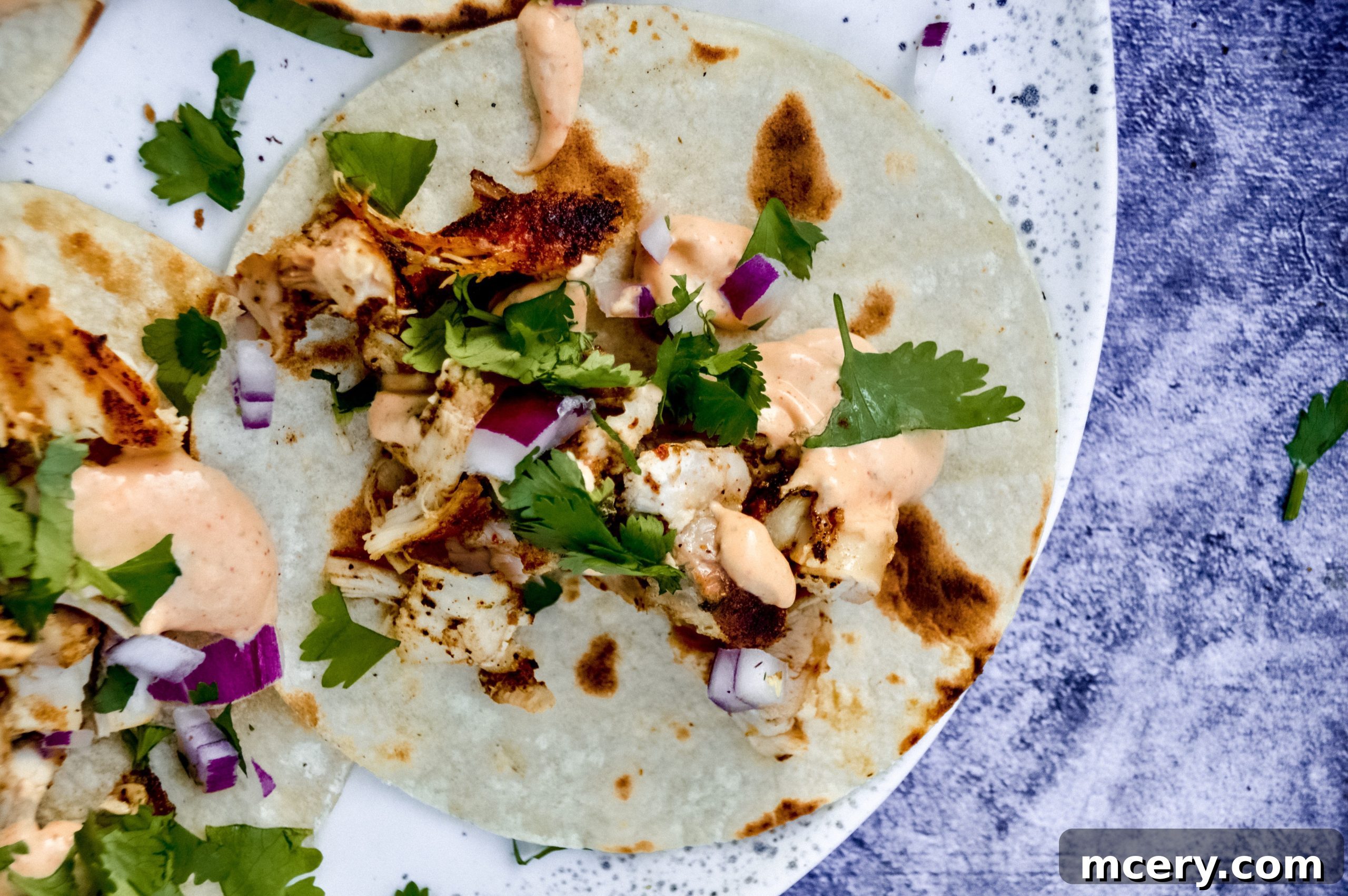Zesty Street Chicken Tacos 7 Close-up of grilled chicken thighs with attractive char marks, cooking on a cast iron grill pan.