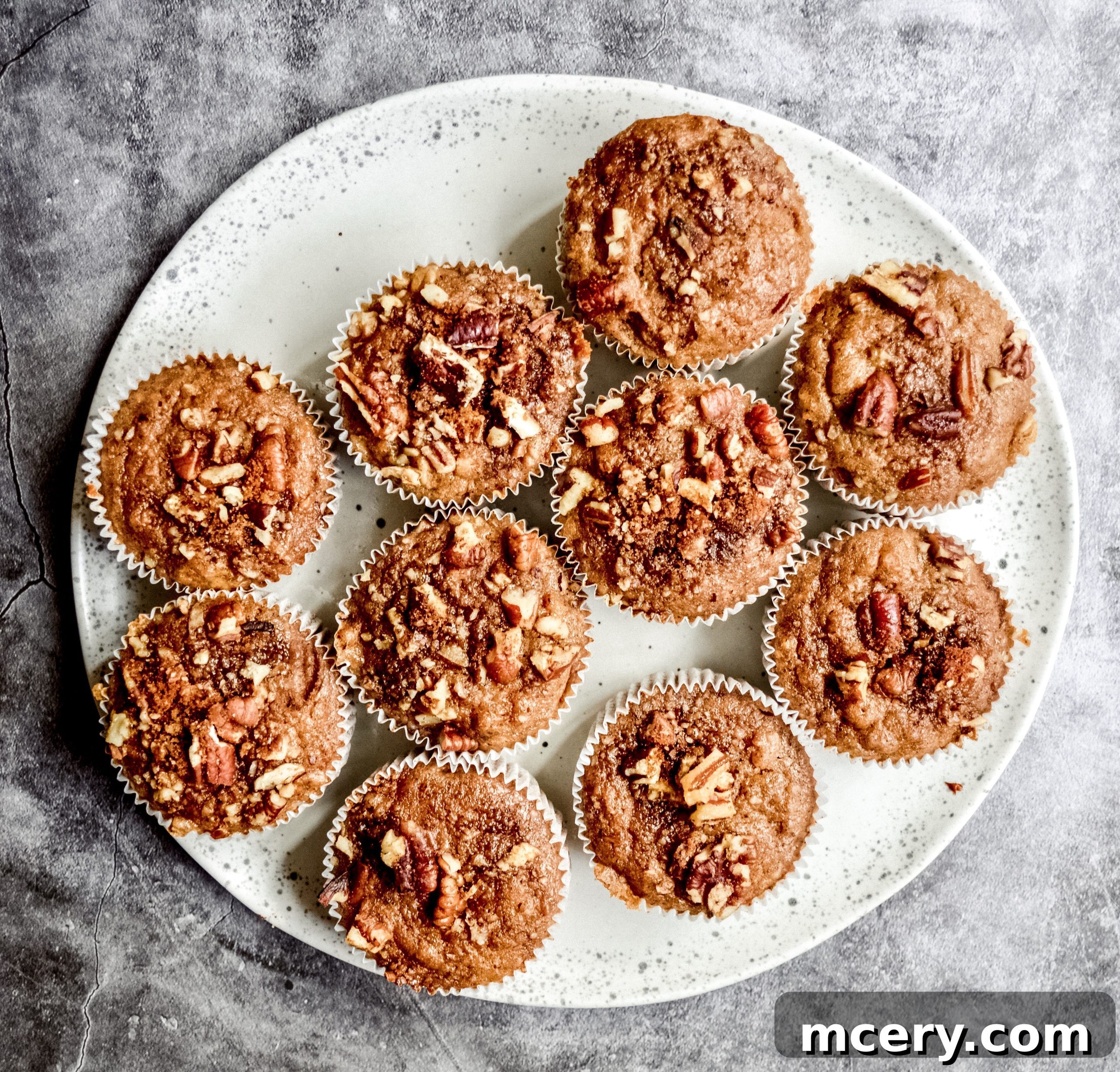 Moist Vegan Banana Cinnamon Muffins 2 Delicious vegan banana cinnamon muffins on a rustic surface.