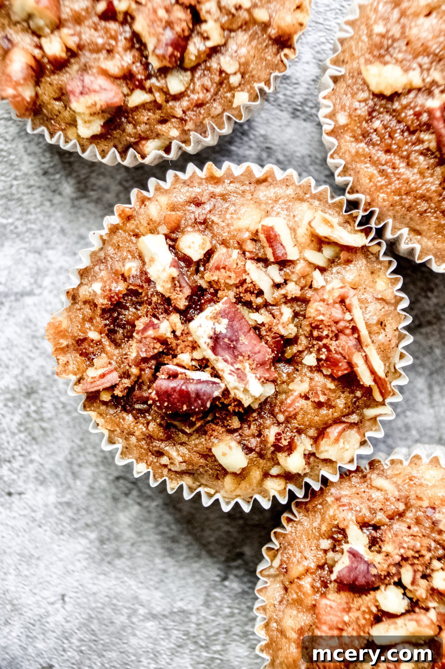Moist Vegan Banana Cinnamon Muffins 4 Three vegan banana cinnamon muffins arranged on a plate, ready to be enjoyed.
