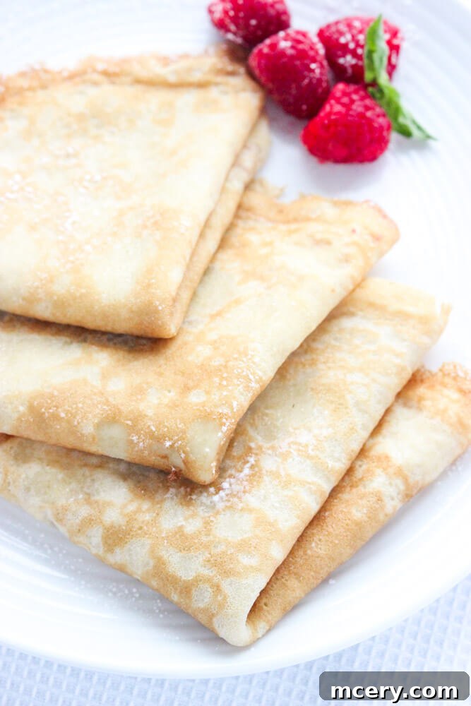 Tropical Coconut Crepes 5 A perfectly cooked coconut oil crepe being folded and prepared for serving.
