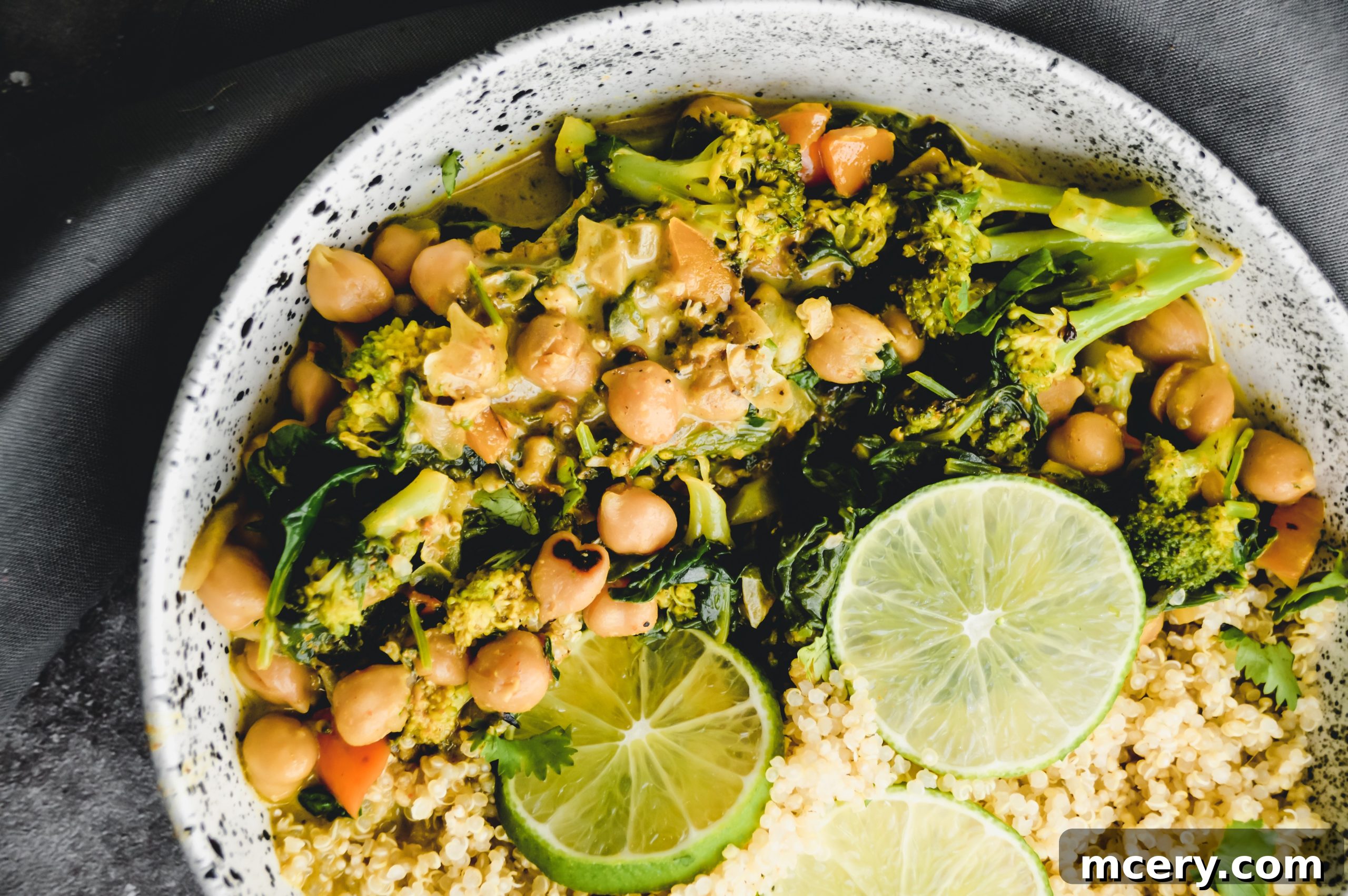 15-Minute Chickpea Curry Quinoa Power Bowl 3 Close-up of the rich and creamy texture of the chickpea curry simmering in a pan, with visible chickpeas and vegetables.