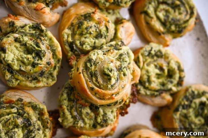 Savory Spinach and Cheese Puff Pastry Swirls 12 Deliciously baked spinach and cheese puff pastry pinwheels