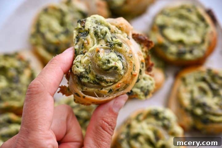 Savory Spinach and Cheese Puff Pastry Swirls 13 Delicious spinach-stuffed mushrooms with melted cheese, perfect for healthy snacking or appetizers.