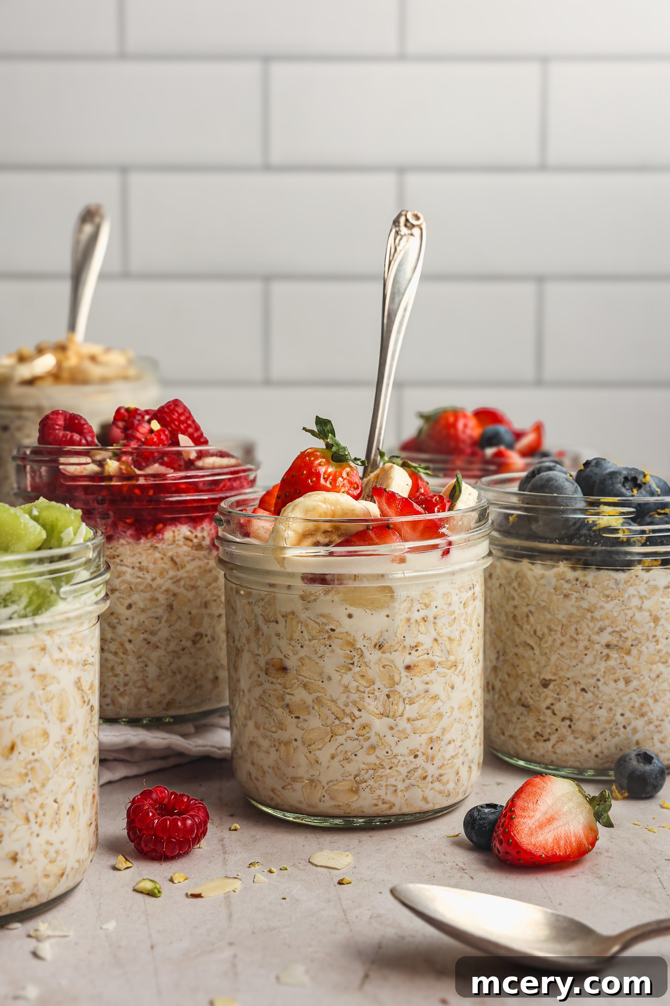 Overnight Oats Your Complete Guide to Oat Varieties and Preparation 2 Prepared overnight oats topped with fruit in glass jars.