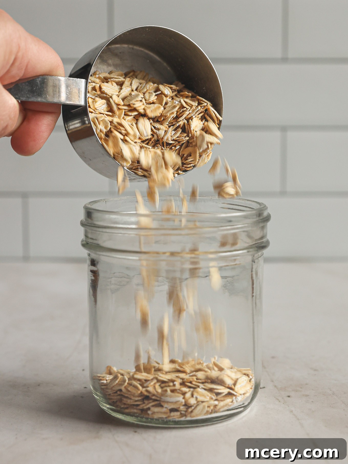 Overnight Oats Your Complete Guide to Oat Varieties and Preparation 4 Dry oats going into a jar.