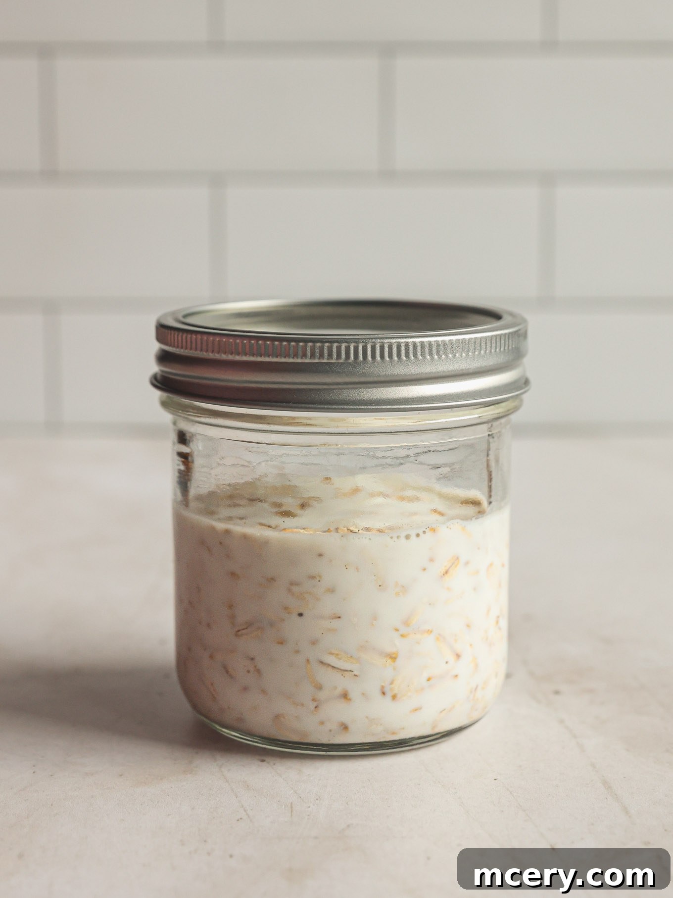 Overnight Oats Your Complete Guide to Oat Varieties and Preparation 7 Closed jar with oats and milk.