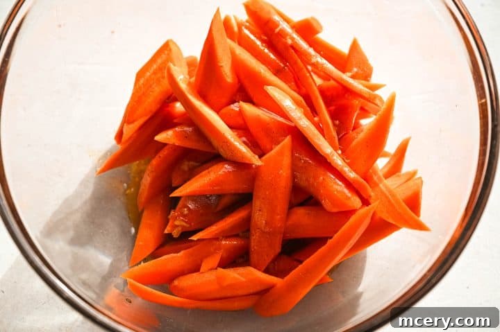 Golden Maple Glazed Carrots 6 Close-up of carrots fully coated with seasoning mixture, ready for roasting.