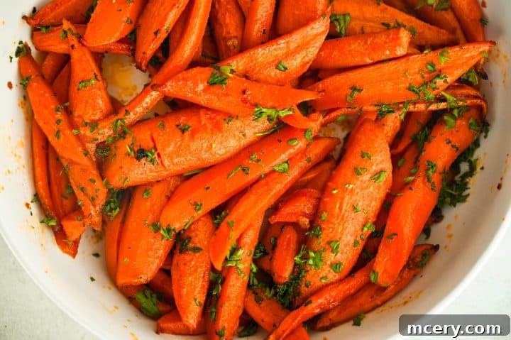 Golden Maple Glazed Carrots 8 Finished maple roasted carrots in a serving dish, garnished with fresh parsley.