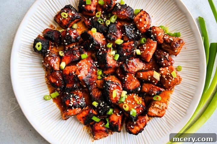 Honey Glazed Salmon Bites with Sesame Ginger and Smoked Paprika 9 Close-up of caramelized honey baked salmon bites with crispy edges, coated in a glossy sesame-ginger glaze straight from the air fryer.
