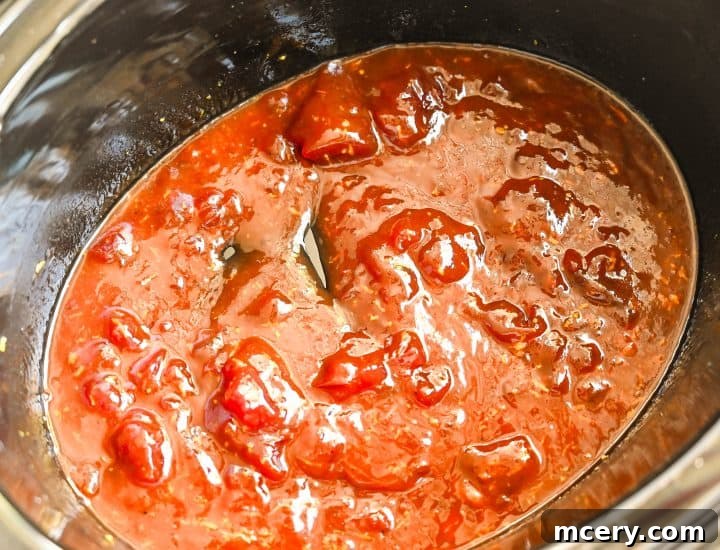 Cranberry Glazed Holiday Meatballs 5 Step 2: Cranberry sauce is added over the meatballs.